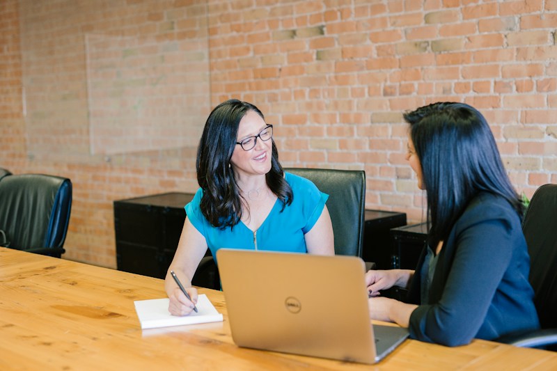 People discussing their work around a table